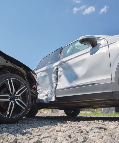 Cars crashed heavily in road accident after collision on city street. Road safety and insurance concept.