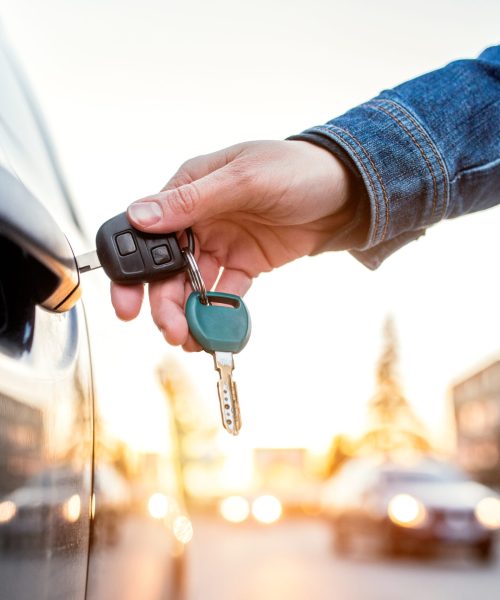 Unrecognizable woman opening her car with a key